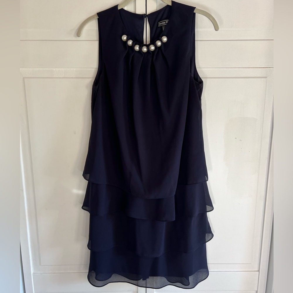 Navy blue knee length cocktail dress with pearl detail on neckline. Size 6
